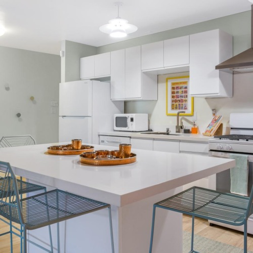 Spacious kitchens with thoughtful details a kitchen with a table and chairs