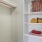 a white shelving unit with books and a basket on it
