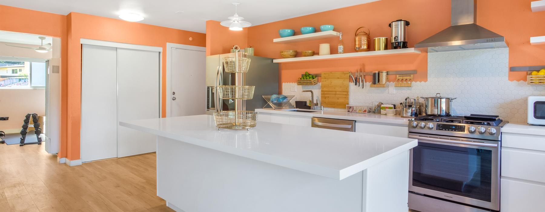 a kitchen with a white counter top